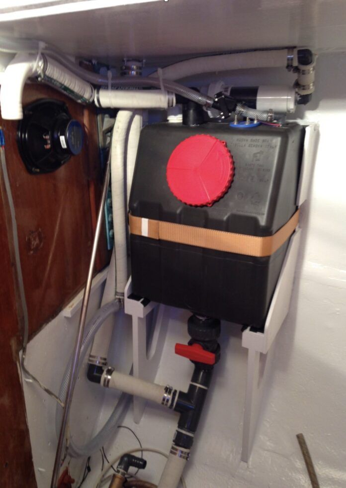 Misirlou’s gravity drain holding tank mid-installation showing tank valve, Tee to deck pump-out fitting and home-made activated charcoal vent filter. (Photo/ Tom Egan)